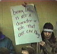 Charlene Teeters holding protest sign
